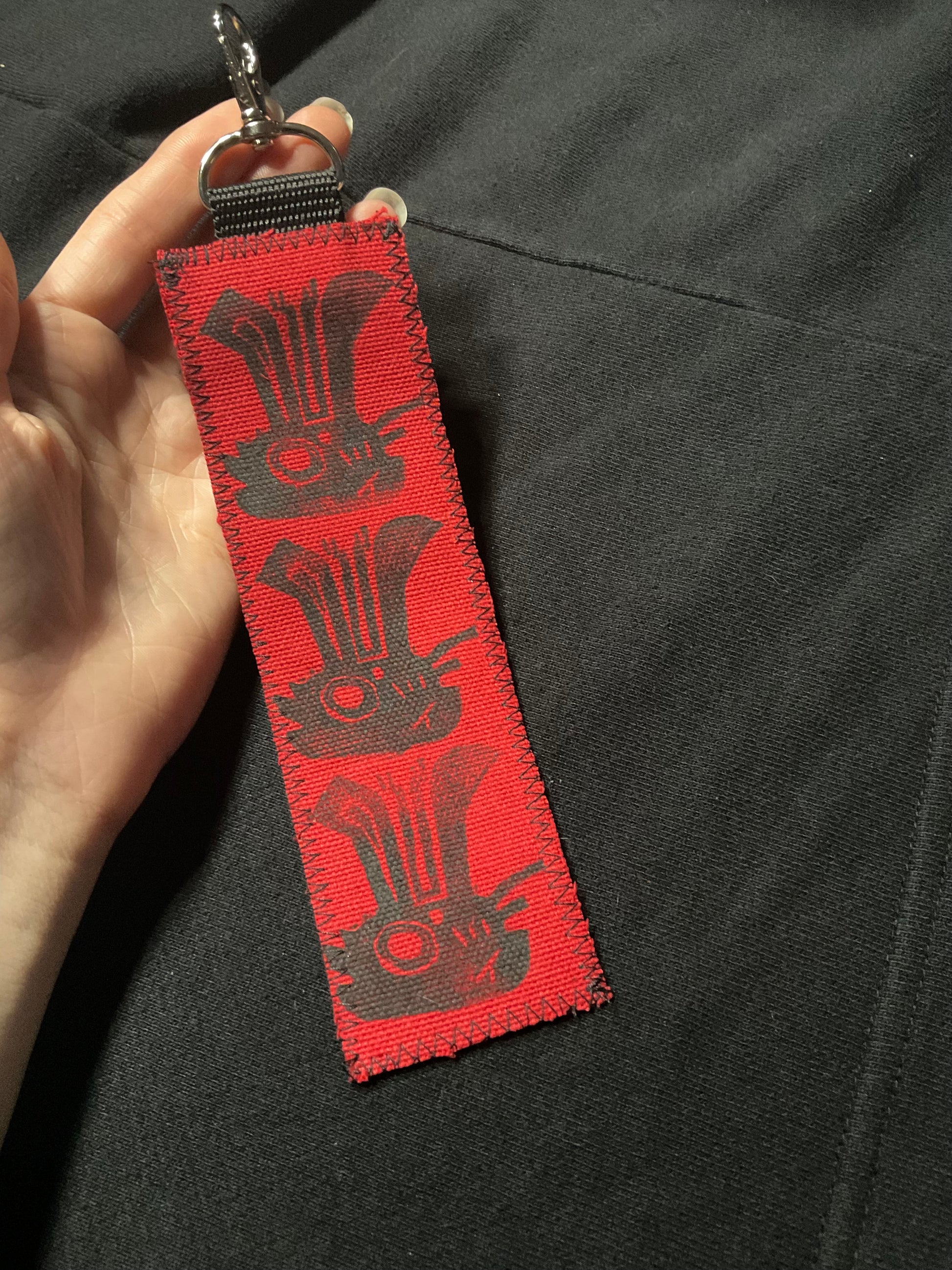 3 black jackalopes printed vertically on fabric.