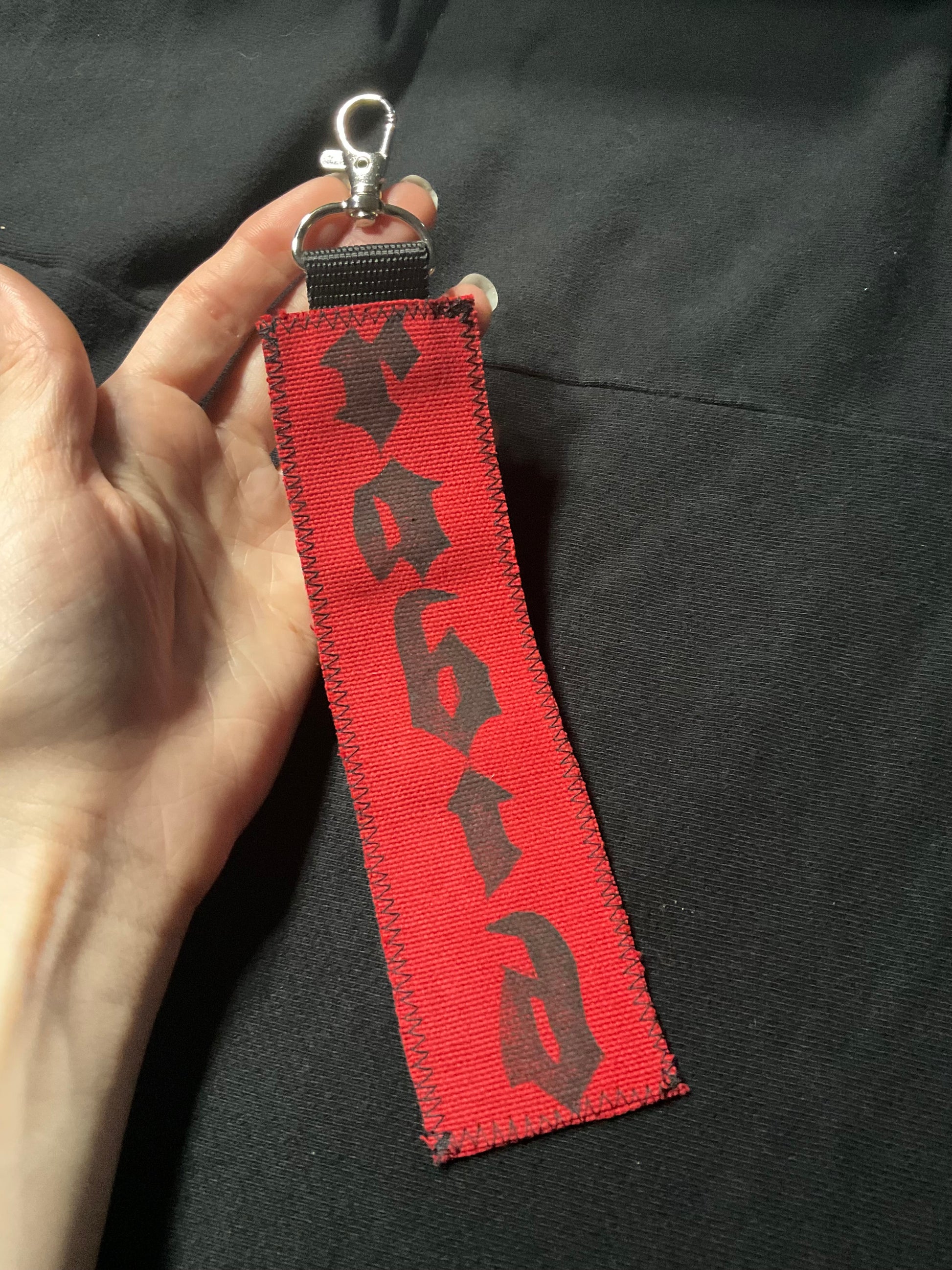 Fabric keychain with the word RABID printed vertically.