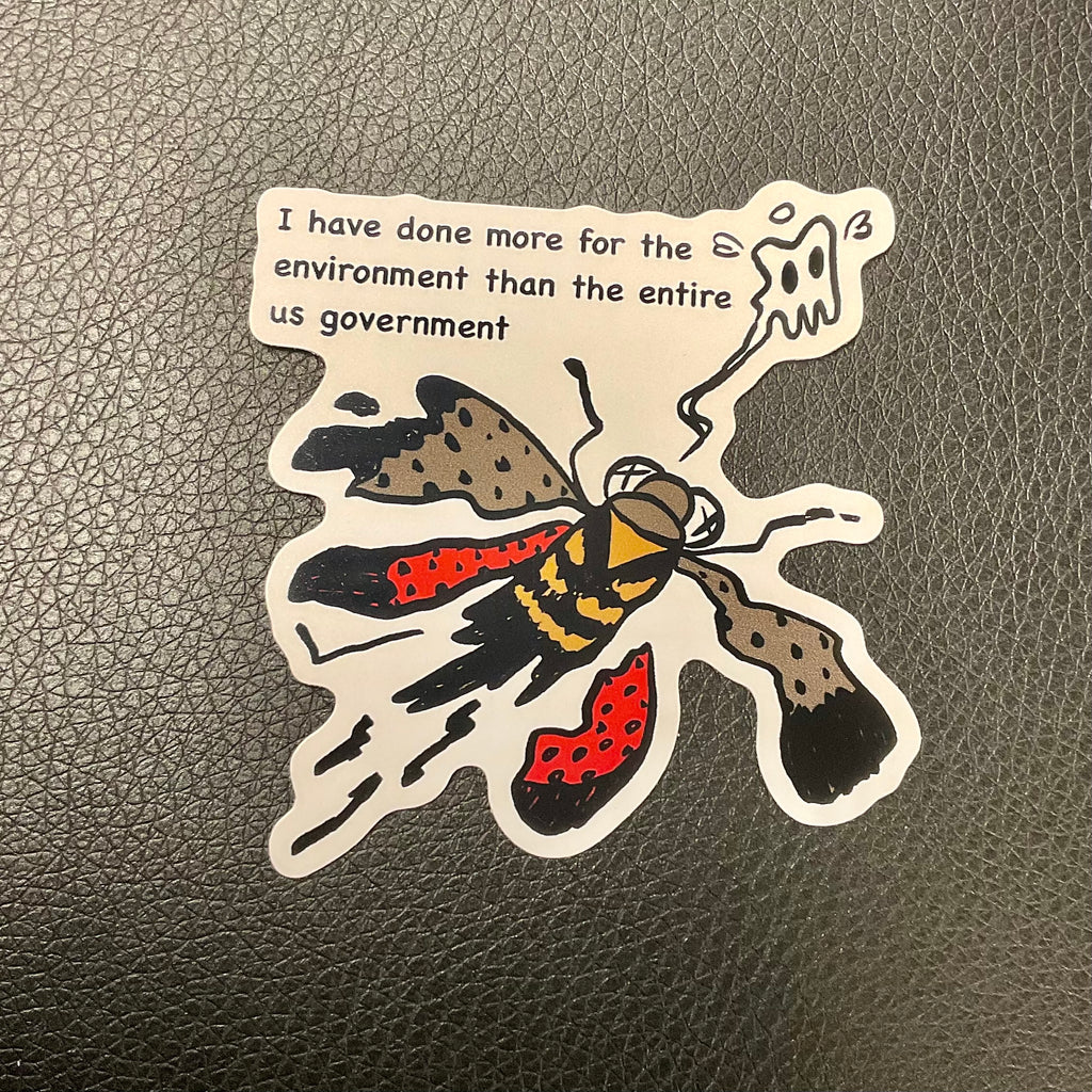 Sticker of smushed lantern fly on flat surface.